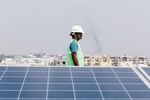 A Fourth Partner employee walks between solar panels